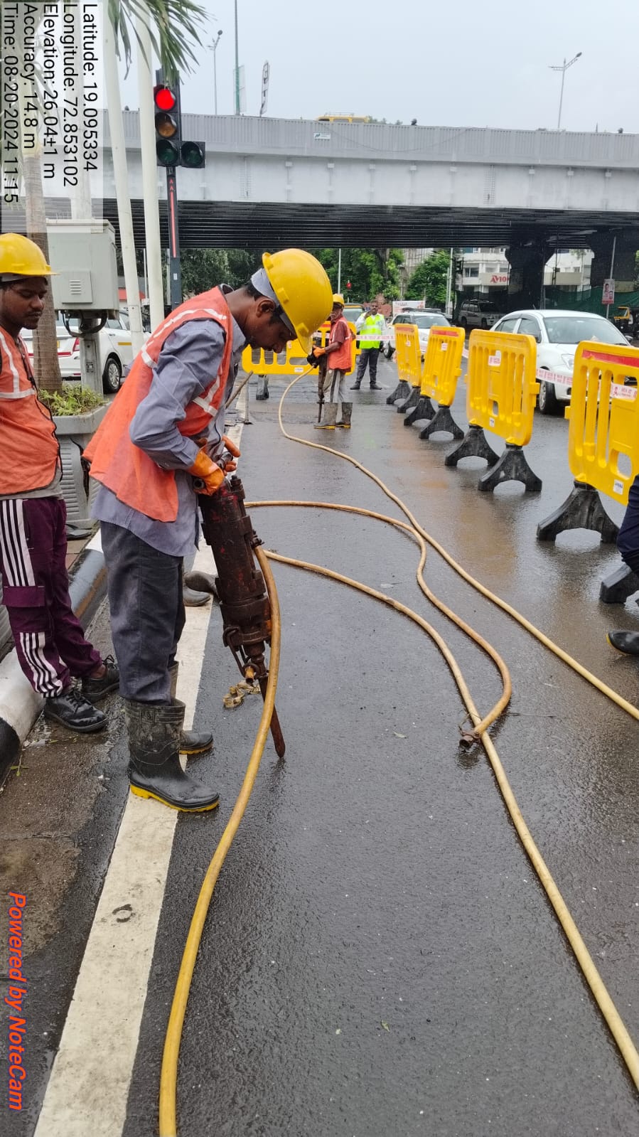 Technician operating a jackhammer for underground duct installation